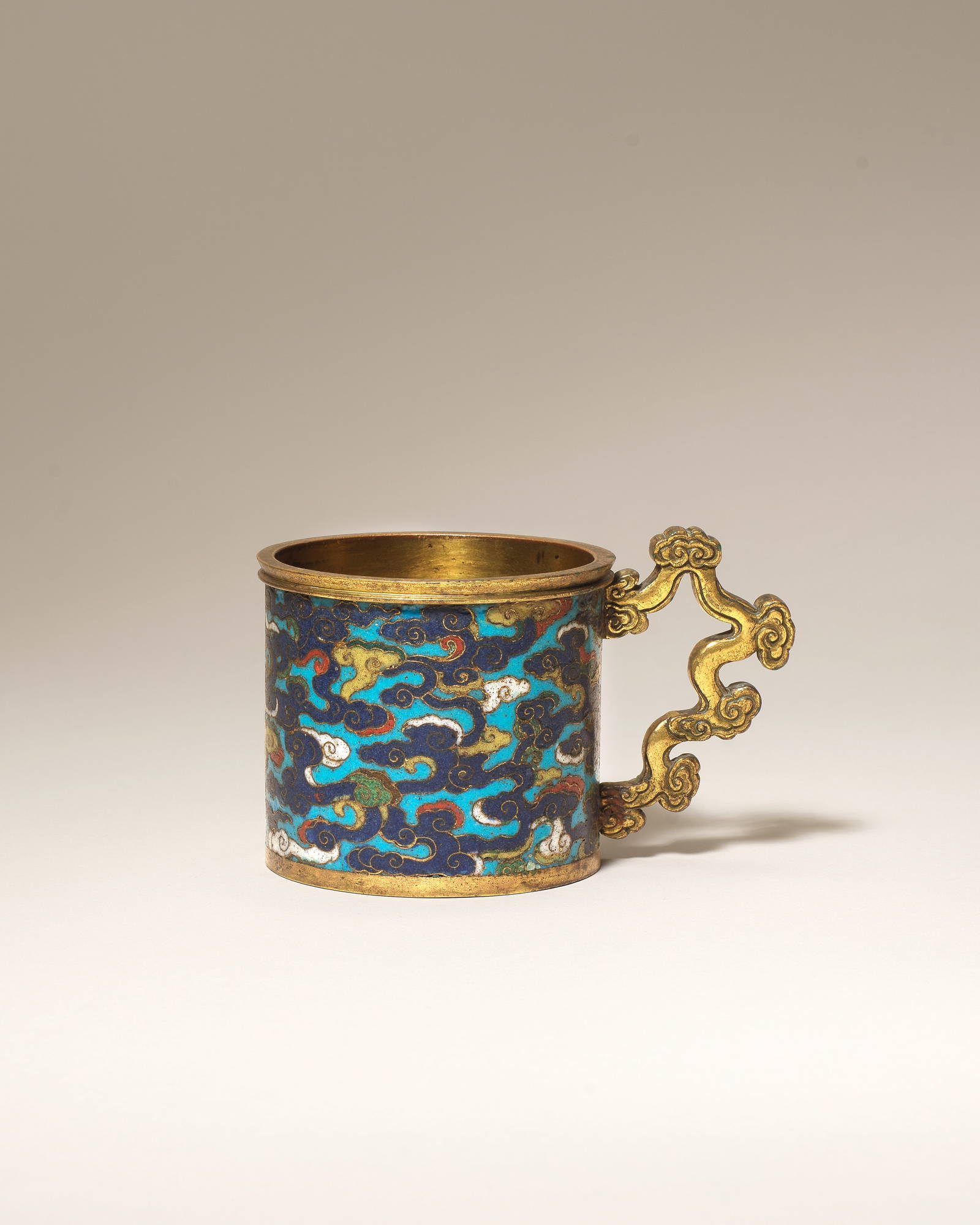 A RARE GILT BRONZE AND CLOISONNÉ ENAMEL 'AUSPICIOUS CLOUDS' MEASURING CUP 16th/17th century