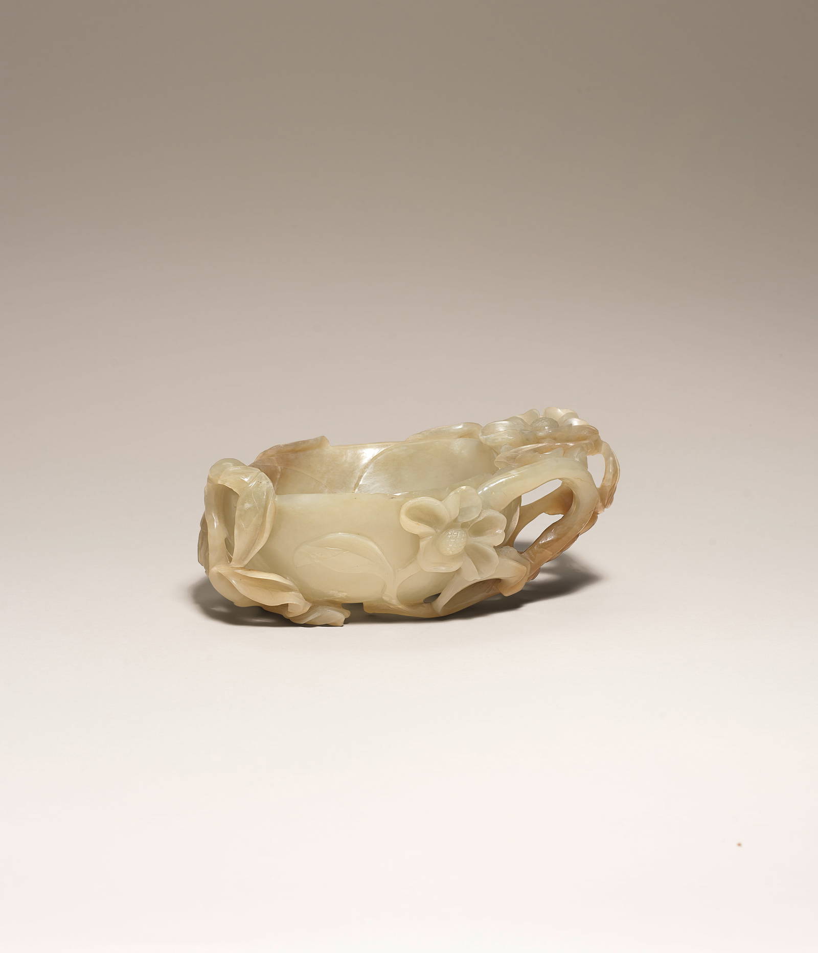 A LARGE PALE GREEN AND RUSSET JADE 'MAGNOLIA' BRUSHWASHER Ming Dynasty