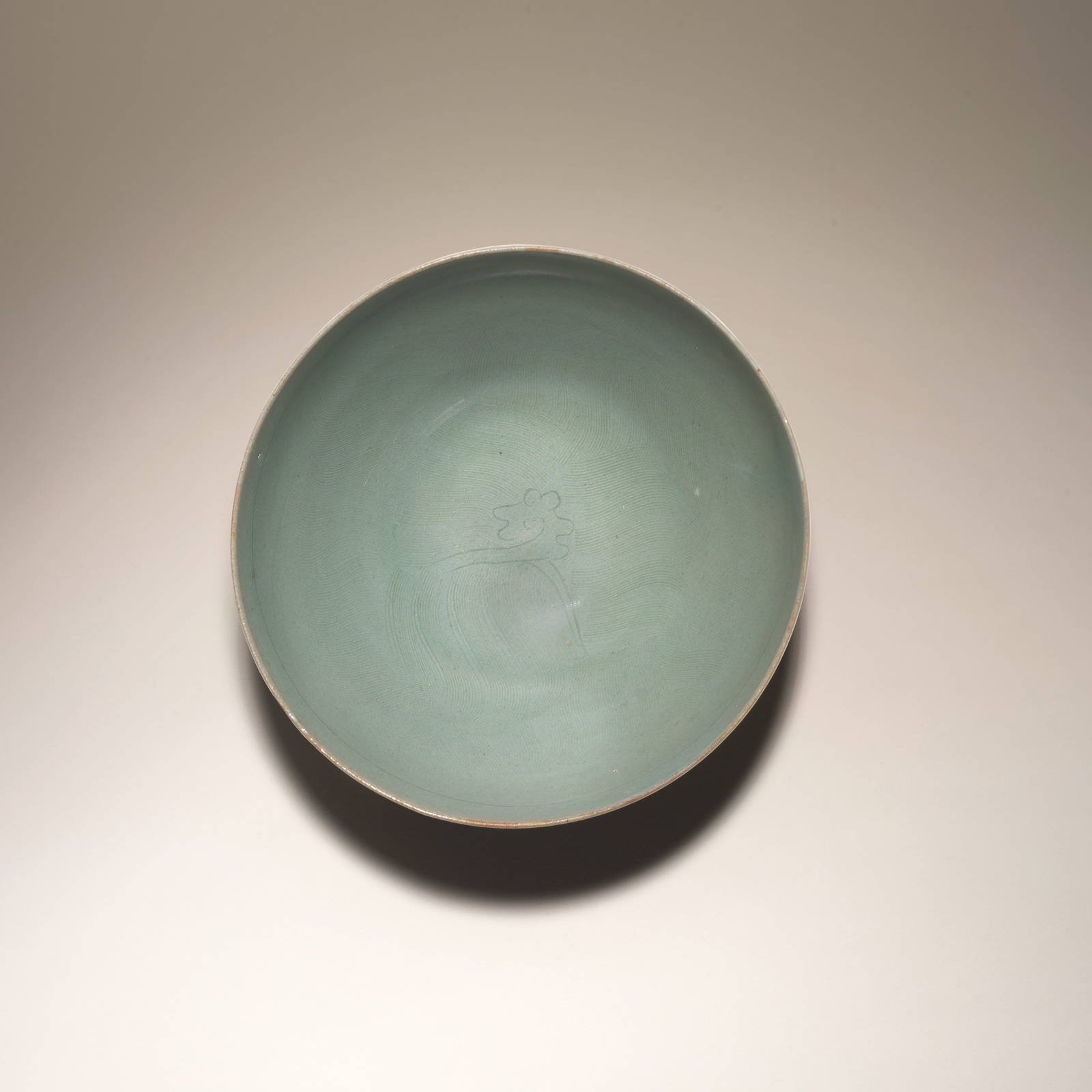 AN INCISED CELADON-GLAZED 'FLORAL' BOWL Goryeo Dynasty, second half 11th century/first half 12th...