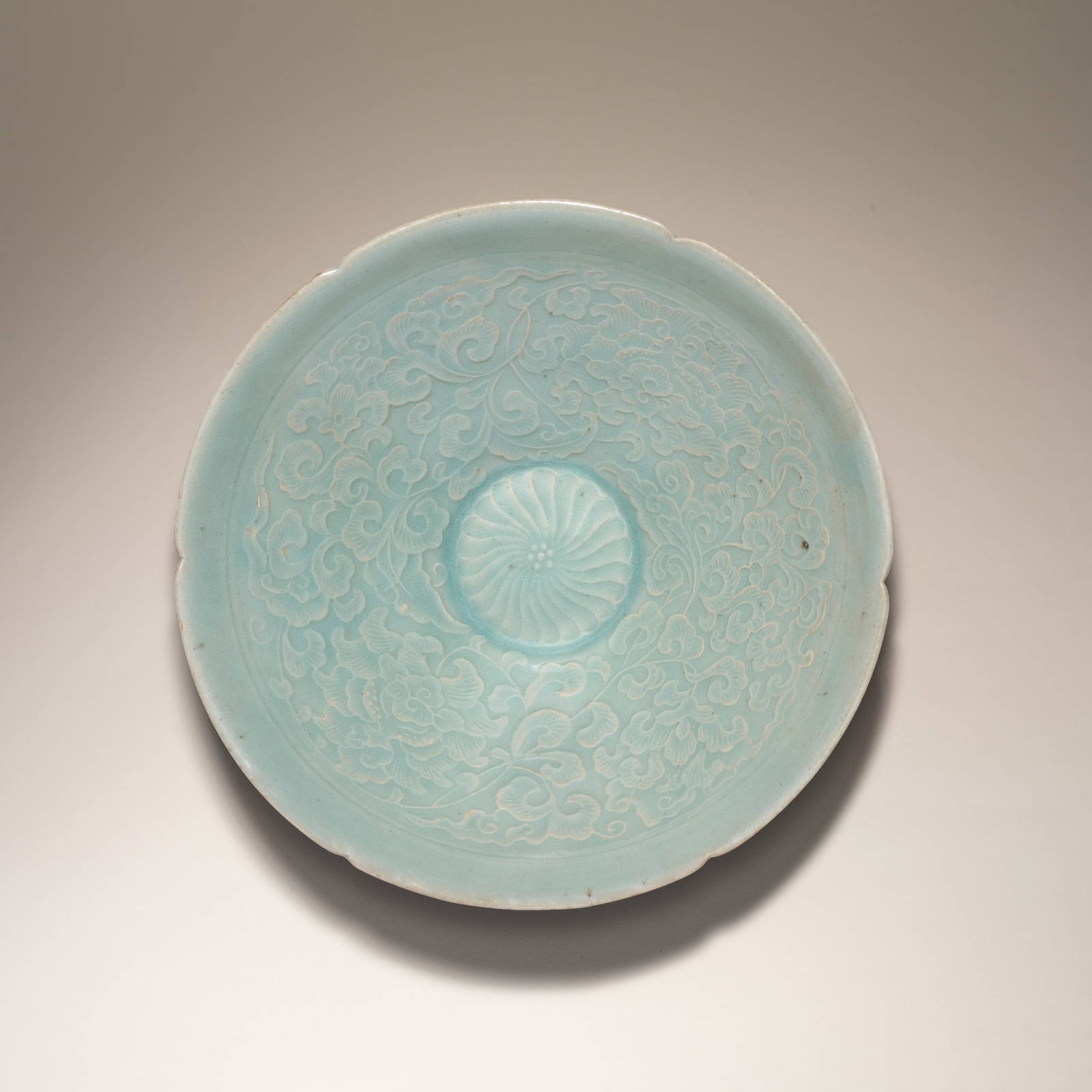 A RARE CELADON-GLAZED MOULDED 'PEONY' BOWL Goryeo Dynasty, 12th century (2)