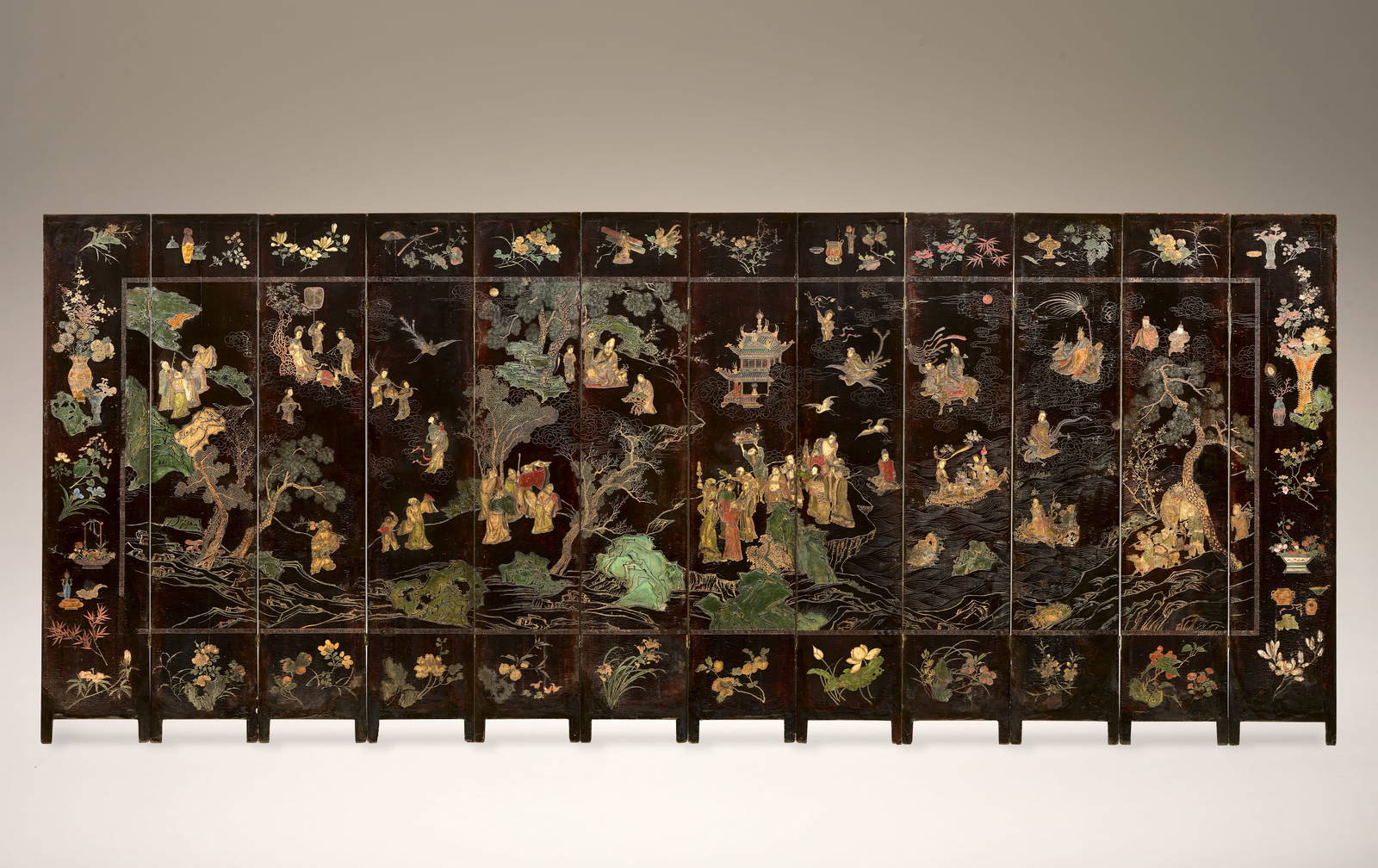 A TWELVE-PANEL COROMANDEL LACQUER 'LONGEVITY BANQUET' SCREEN Kangxi