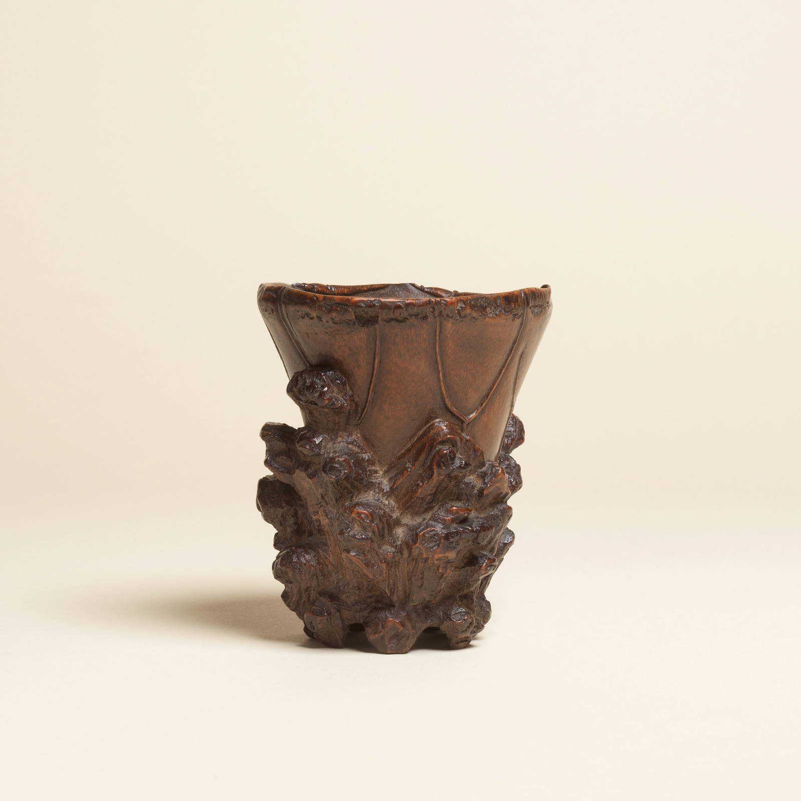 A RARE CARVED BAMBOO 'LOTUS AND ROCKWORK' LIBATION CUP 17th/18th century