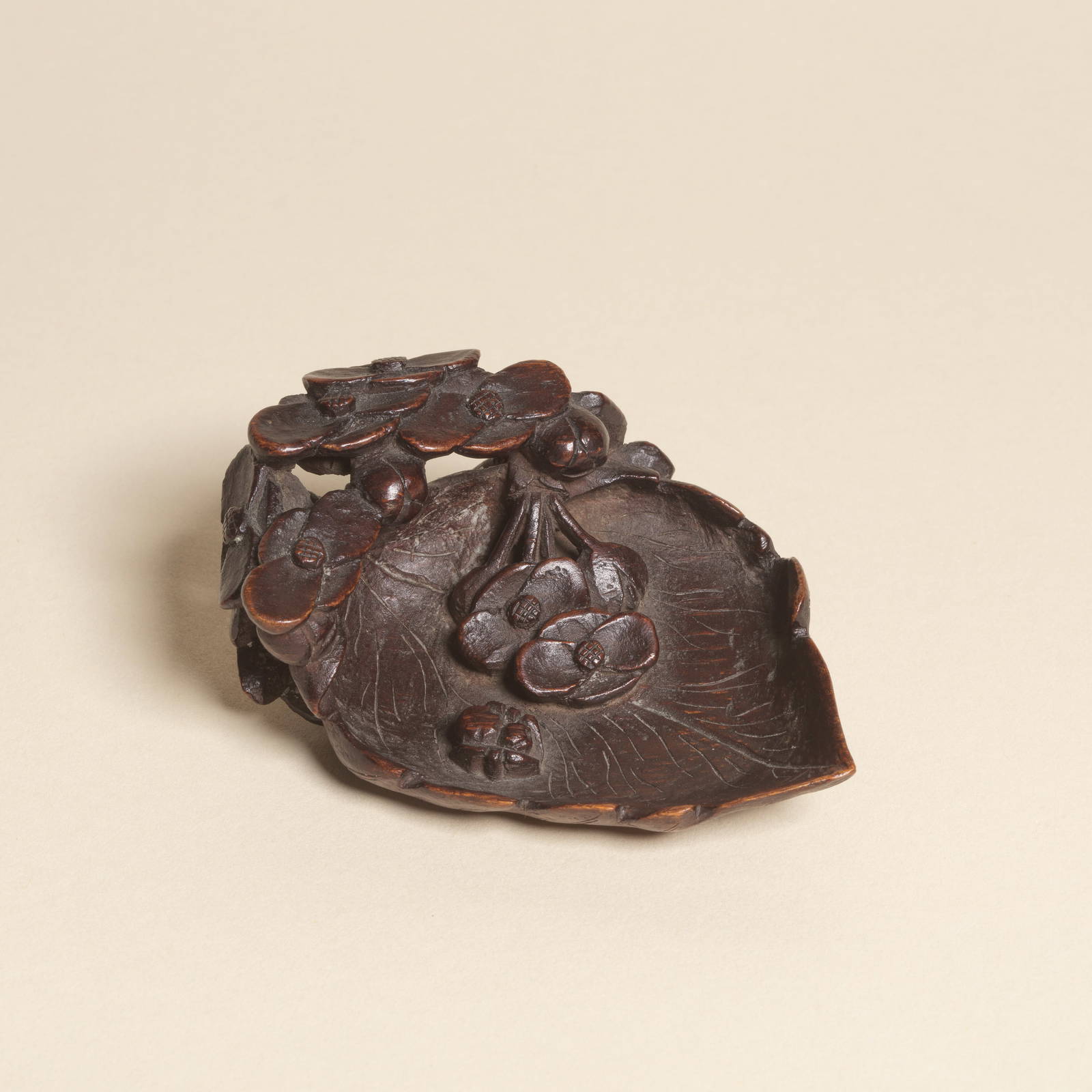 A CARVED BAMBOO 'PLUM BLOSSOM' SCOOP OR INK-PALETTE, BITIAN 17th century