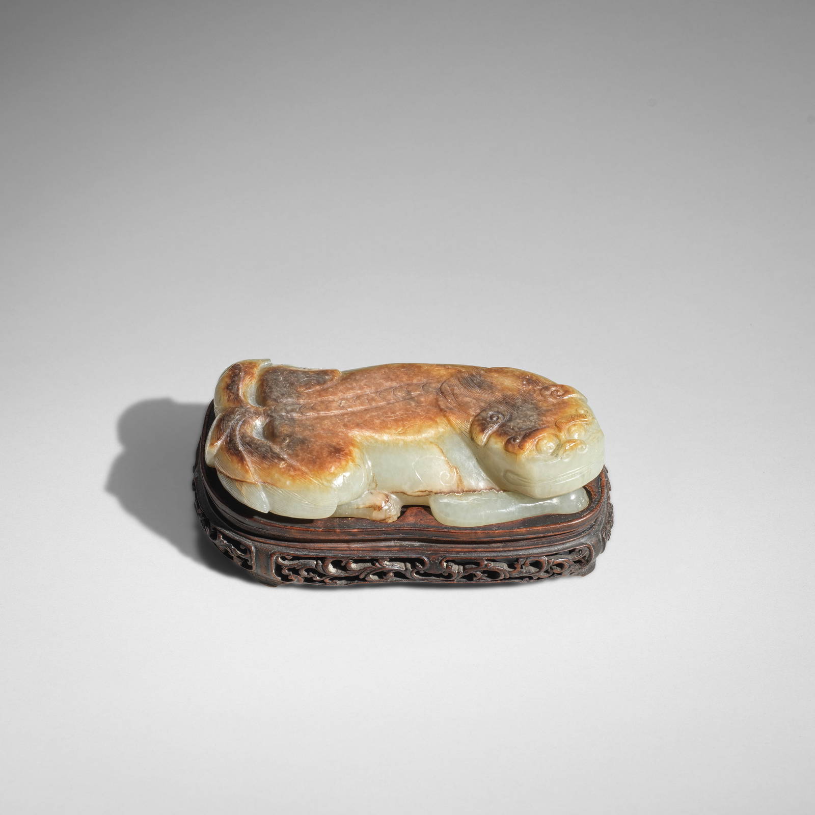 A RARE PALE GREEN AND RUSSET JADE 'BUDDHIST LION' SCROLL WEIGHT 17th century (2)