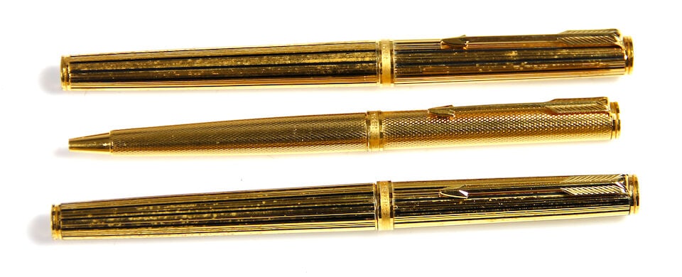PARKER: Lot of 3 Gold-Plated Instruments: PARKER: Lot of 3 Gold-Plated Instruments Alternating black & gold pinstriped fountain pen, converter-filler, fine 18K gold nib, inked, with matching rollerball, both with surface wear. With barleycorn