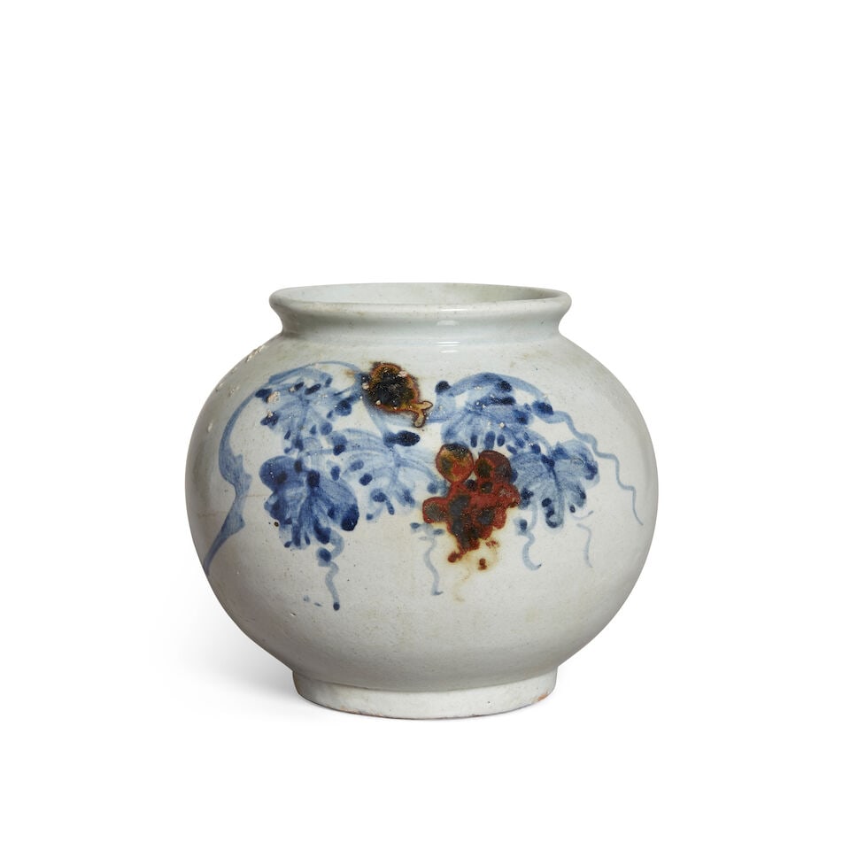 A KOREAN UNDERGLAZE-BLUE AND COPPER-RED-DECORATED 'GRAPEVINE' GLOBULAR JAR Late Joseon dynasty: A KOREAN UNDERGLAZE-BLUE AND COPPER-RED-DECORATED 'GRAPEVINE' GLOBULAR JAR Late Joseon dynasty 6 5/8in (16.7cm) high Lot to be sold without reserve. This lot is subject to the following lot symbols: &
