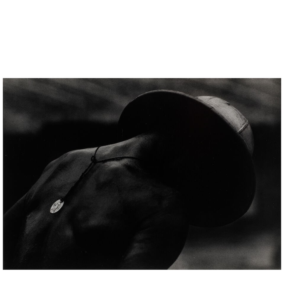 W. Eugene Smith (1918-1978); Leper Patient and Religious Medal at Dr. Albert Schweitzer's;: W. Eugene Smith (1918-1978) Leper Patient and Religious Medal at Dr. Albert Schweitzer's, 1954 Gelatin silver print, printed before 1978; the photographer's estate stamp on the verso. 10 1/8 x 12 7/8