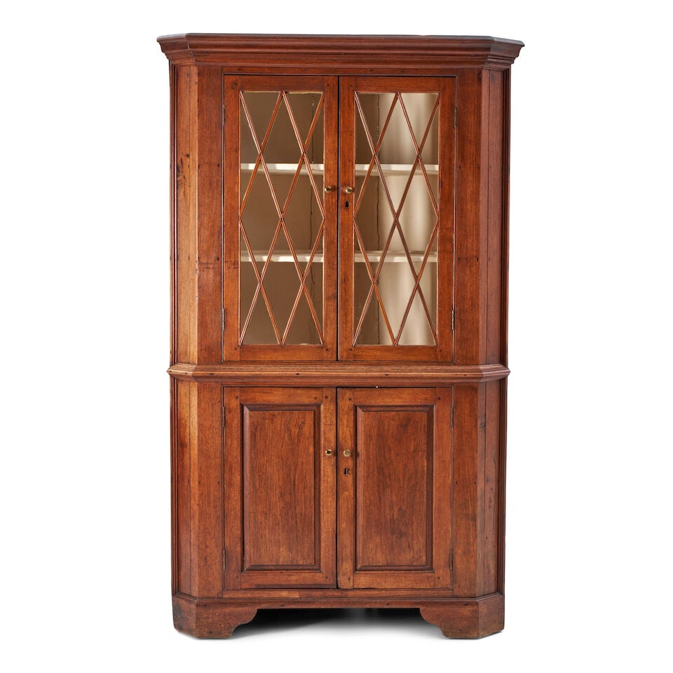 Chippendale Walnut and Pine Corner Cupboard North America, late 18th century: Chippendale Walnut and Pine Corner Cupboard North America, late 18th century The upper section with glazed doors opening onto interior with three fixed shelves, over a two-shelf cupboard, the base fac