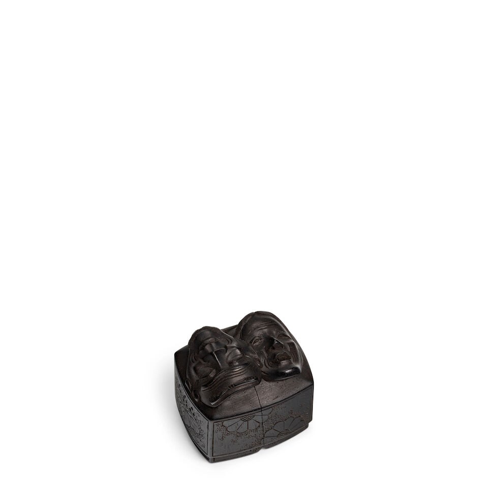 SATŌ MASAYOSHI (1819-1865) A Ebony Wood Netsuke of Noh Masks on a Box Containing a Miniatur...