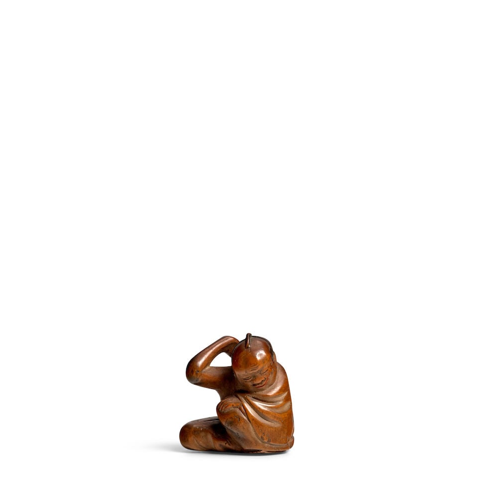ARTIST UNKNOWN A Wood Netsuke of a Man Scratching his Back Meiji era (1868-1912), late 19th century