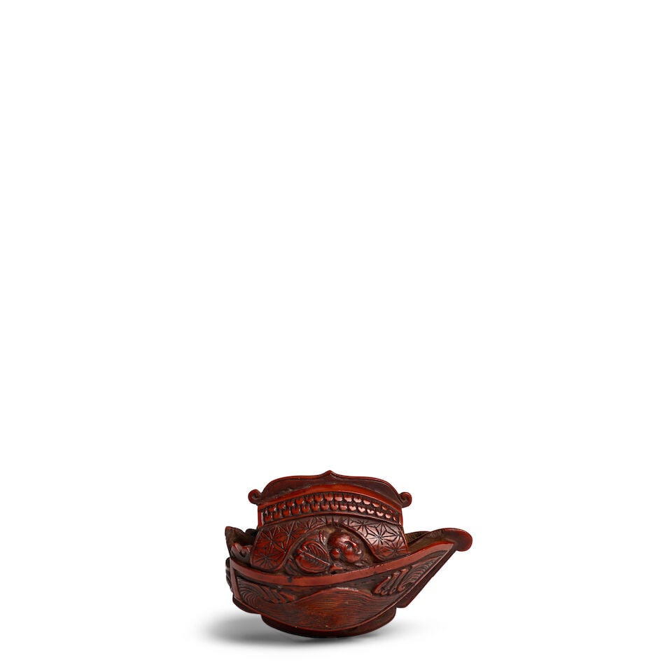 A FRUIT NUT NETSUKE AND TWO WOOD NETSUKE Edo period (1615-1868), 19th century (3)