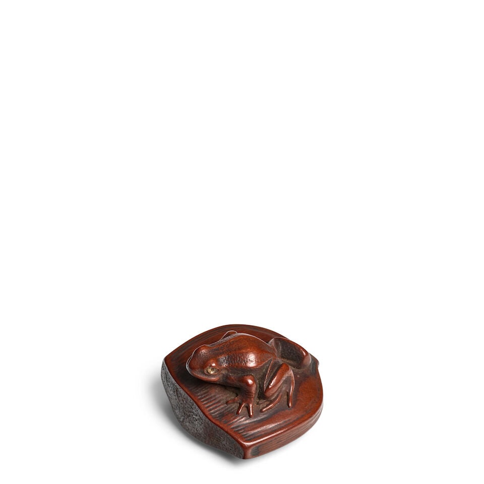 ARTIST UNKNOWN A Wood Netsuke of a Frog on a Chestnut Edo period (1615-1868), 19th century