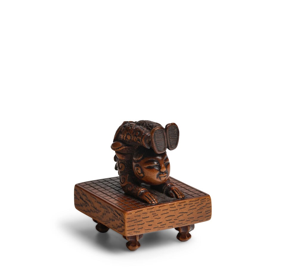 IKKO (ACTIVE EARLY 19TH CENTURY) A Wood Netsuke of a Child Acrobat Edo period (1615-1868), 19th ...