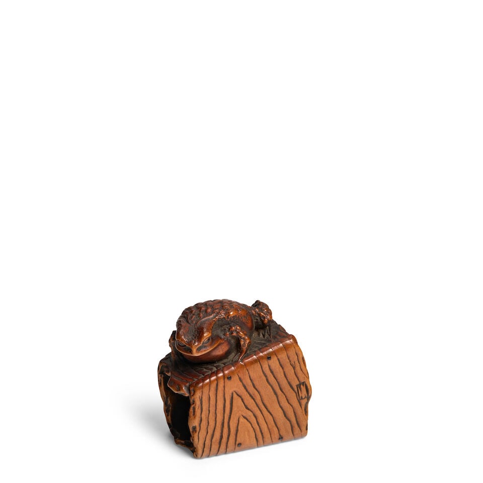 MASANAO OF ISE (ACTIVE 19TH CENTURY) A Wood Netsuke of a Toad on a Bucket Edo period (1615-1868)...