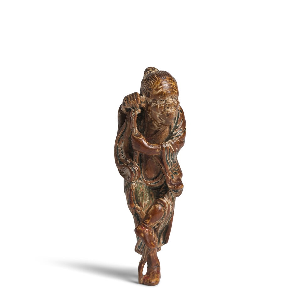 ATTRIBUTED TO YOSHIMURA SHŪZAN (ACTIVE LATE 18TH CENTURY) A Painted-Wood Netsuke of a Senni...