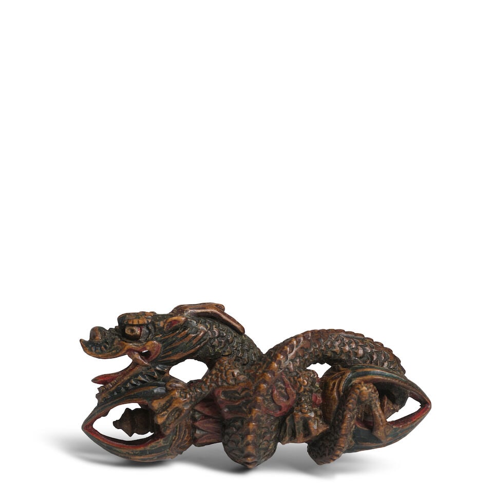 A PAINTED WOOD NETSUKE DRAGON ON A KONGŌ (VAJRA) Edo period (1615-1868), 18th/19th century