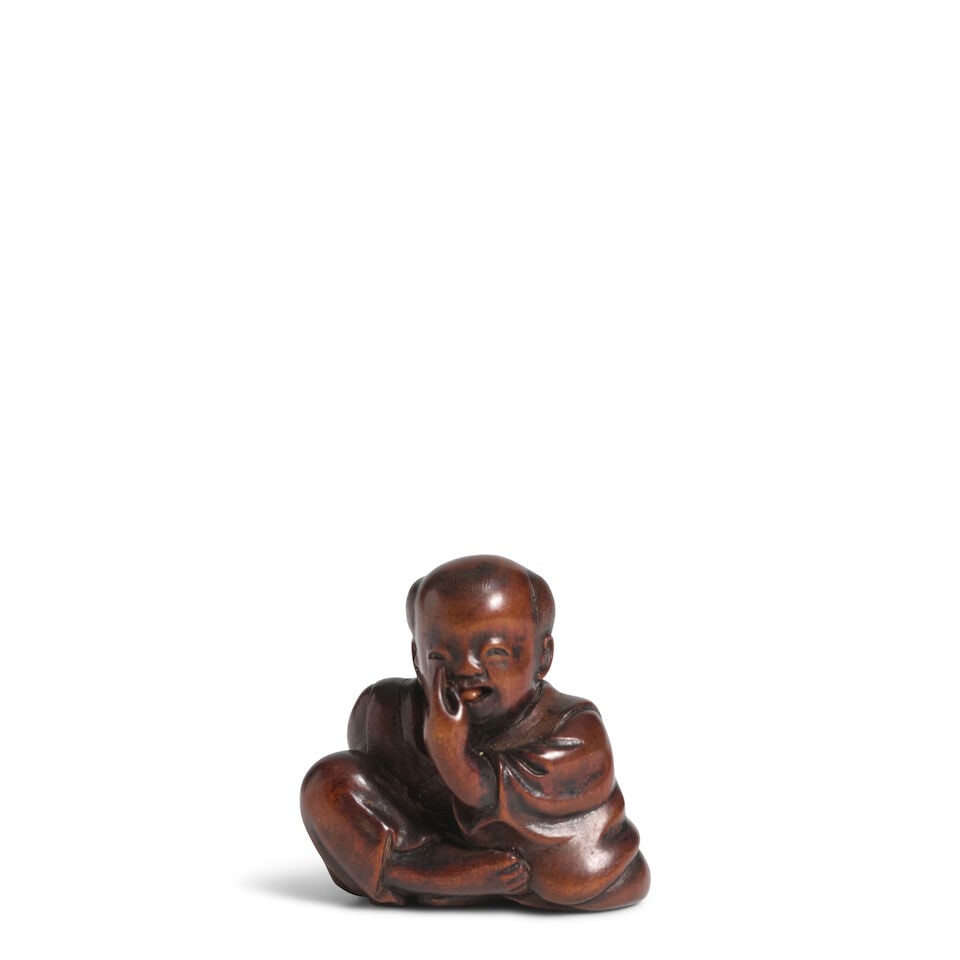 MIWA (ACTIVE LATE 18TH/EARLY 19TH CENTURY) A Wood Netsuke of Seated Boy Edo period (1615-1868), ...