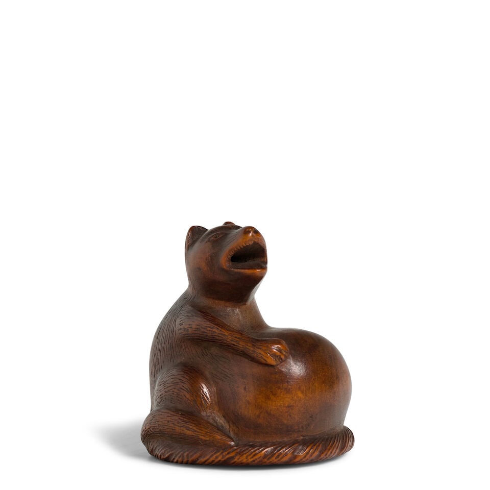 TOMONOBU (ACTIVE CIRCA 1780-1800) A Wood Netsuke of a Tanuki (Badger) Edo period (1615-1868), 18...