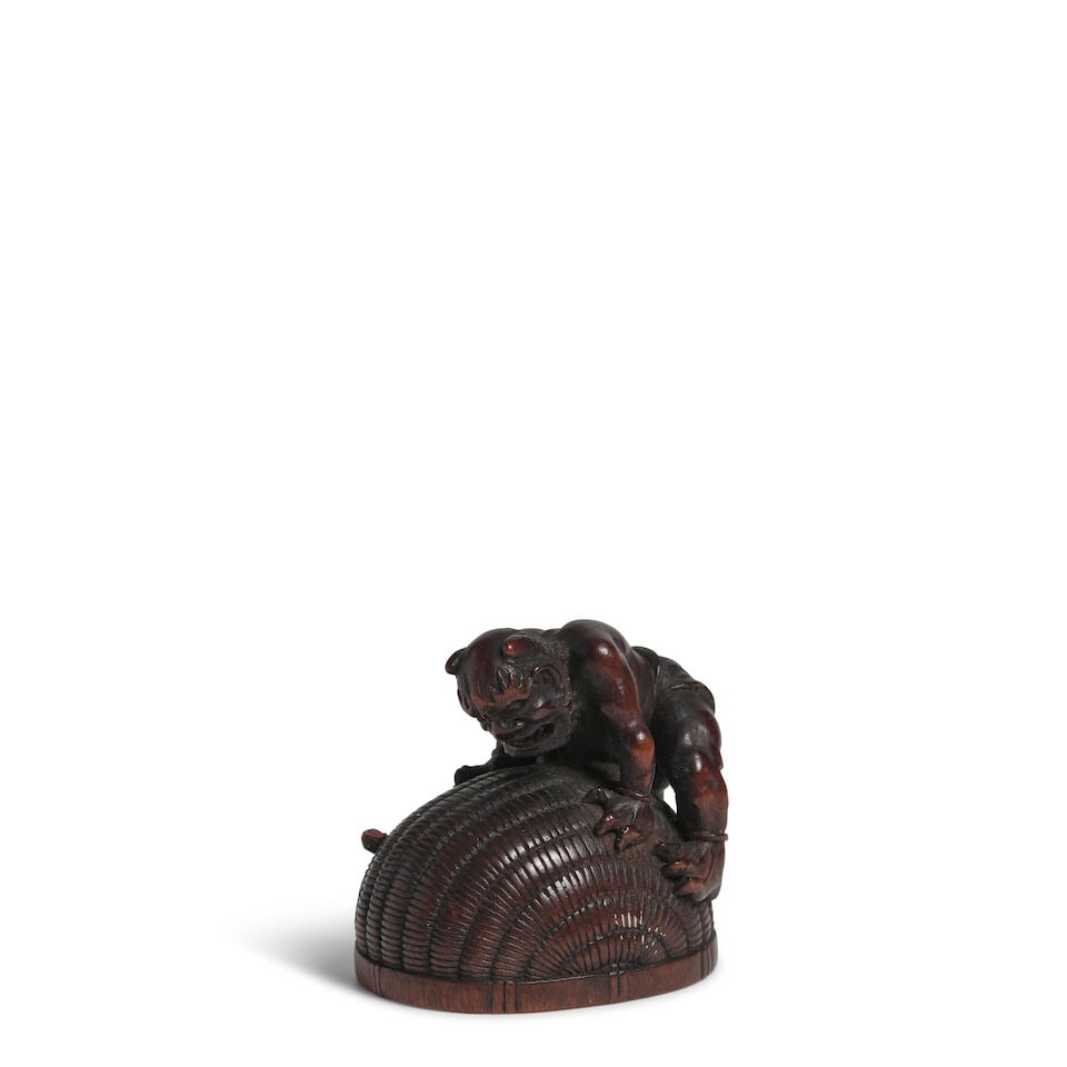 HŌKYŪDŌ ITSUMIN (ACTIVE 19TH CENTURY) A Wood Netsuke of Shoki Trapped by an Oni E... (1 of 2)