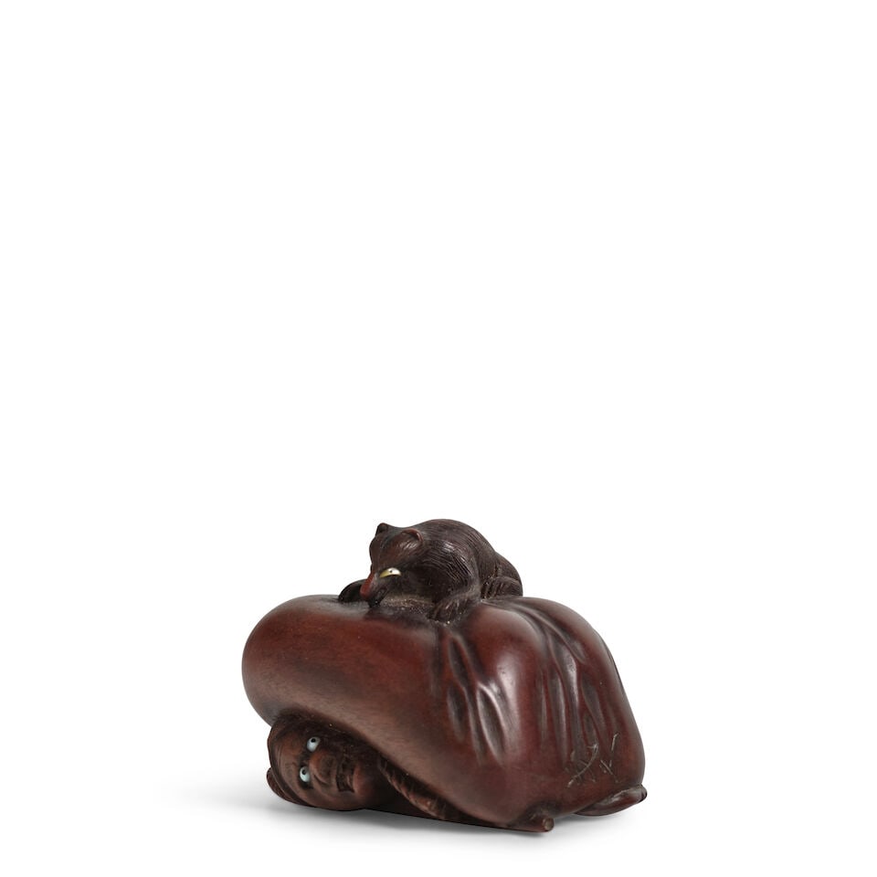 YOSHIHISA (DATES UNKNOWN) A Wood Netsuke of a Fox and a Hunter Edo period (1615-1868), 19th century