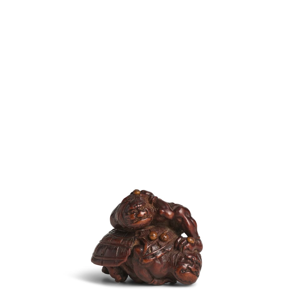 KOKEI (ACTIVE 19TH CENTURY) A Wood Netsuke of Two Cowering Oni (Demons) Edo period (1615-1868), ...