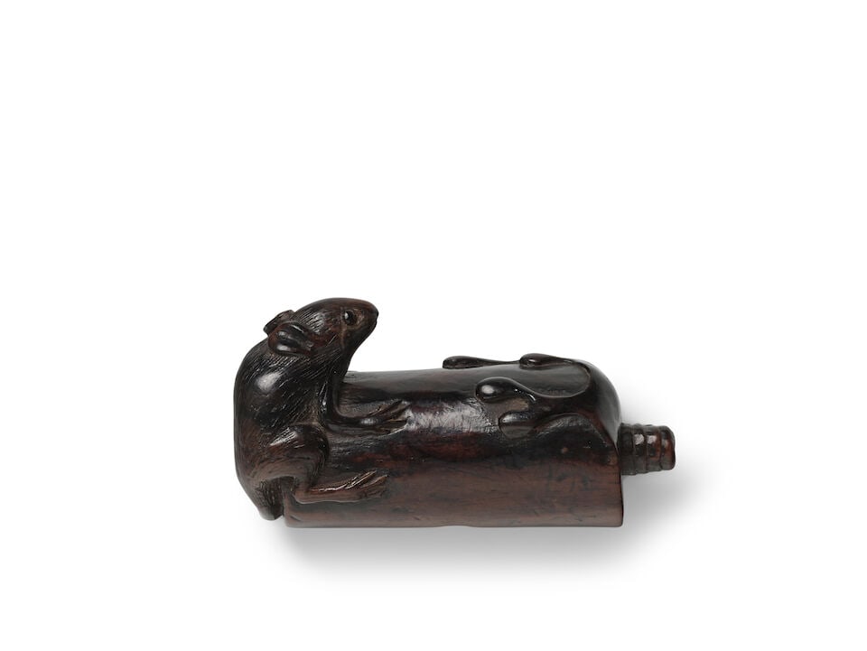 A WOOD NETSUKE OF A RAT ON A CANDLE Edo period (1615-1868) or Meiji era (1868-1912), 19th century
