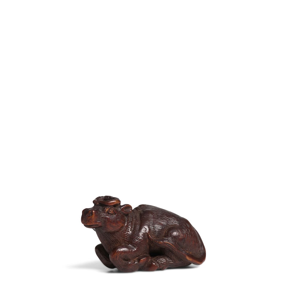 KOKEI (ACTIVE 19TH CENTURY) A Wood Netsuke of a Recumbent Buffalo Edo period (1615-1868), early ...
