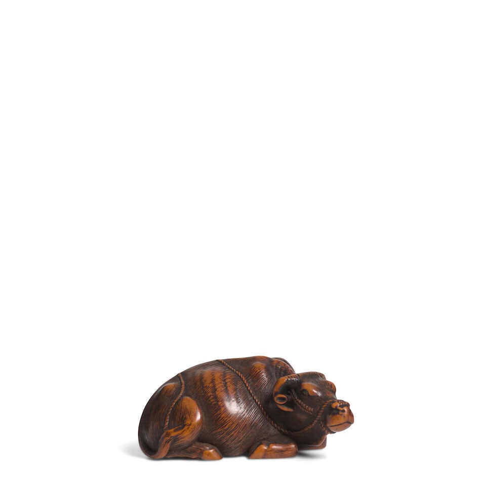 SHŌMIN (SEIMIN, DATES UNKNOWN) A Wood Netsuke of a Recumbent BuffaloEdo period (1615-1868),...