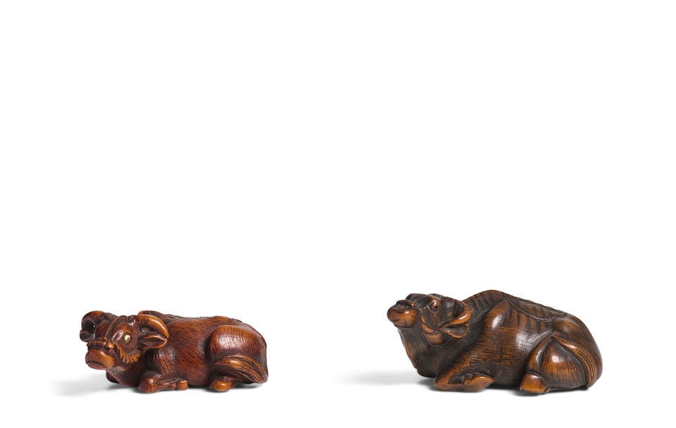 TWO WOOD NETSUKE OF RECUMBENT BUFFALO Edo period (1615-1868), 18th/19th century (2)