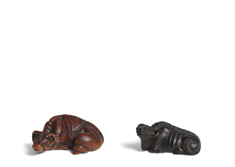 A BOXWOOD NETSUKE OF A BUFFALO AND AN EBONY WOOD NETSUKE OF A BUFFALO Edo period (1615-1868), 18...