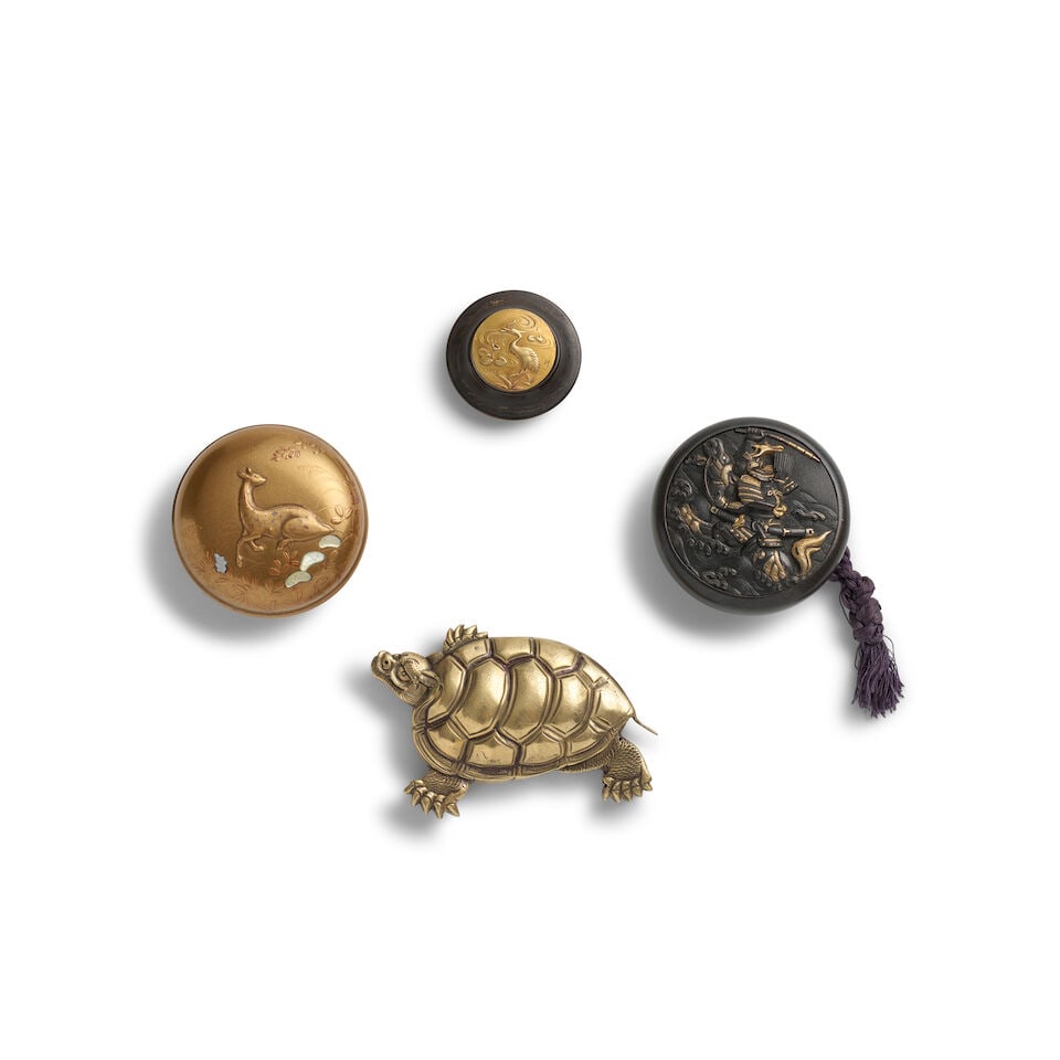 TWO KAGAMIBUTA NETSUKE, A MANJU NETSUKE, AND A BRASS FIGURAL NETSUKE Edo period (1615-1868) or M...
