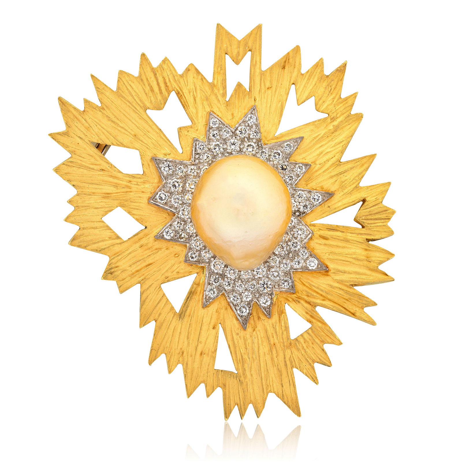 GRIMA: CULTURED PEARL AND DIAMOND BROOCH,: GRIMA: CULTURED PEARL AND DIAMOND BROOCH, CIRCA 1986 The cultured pearl of golden tint to a radiating brilliant-cut diamond and textured surround, signed Grima, length 5.3cm Footnotes: Please note thi