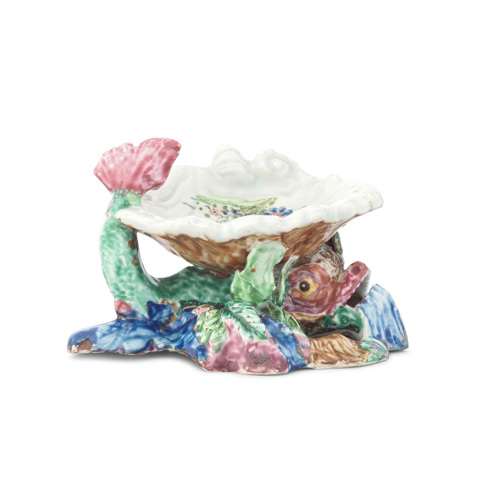 An important 'mushroom-glazed' Bow shell salt, circa 1746-48: An important 'mushroom-glazed' Bow shell salt, circa 1746-48 The finely modelled fluted shell painted in famille rose style to the centre with trailing flowering plants, with a brown exterior, support