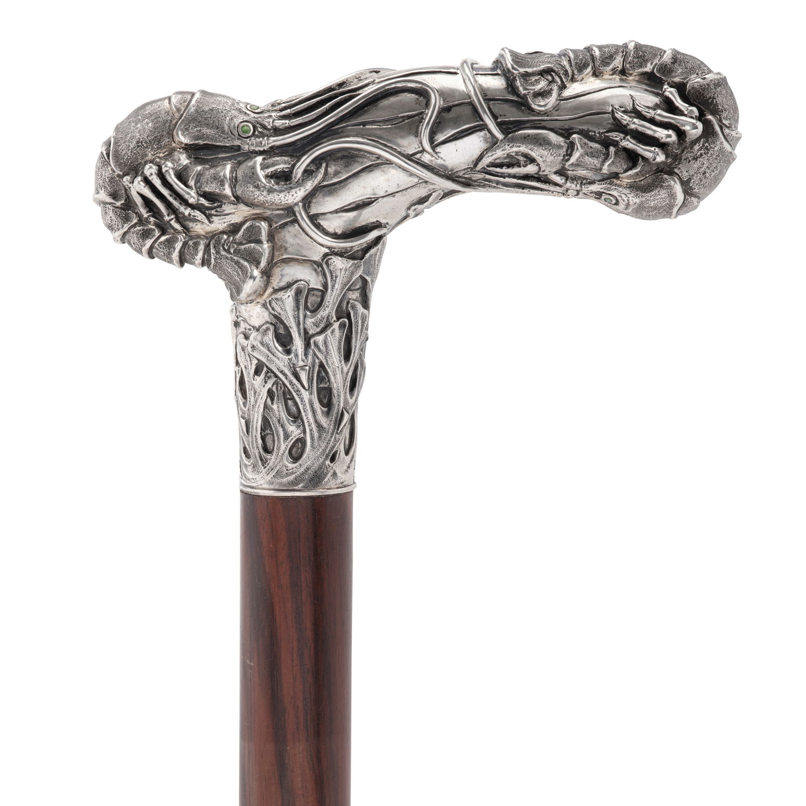 A DANISH SKØNVIRKE PERIDOT INSET 826 STANDARD SILVER OCEAN FLOOR CANEAttributed to Christia...: A DANISH SKØNVIRKE PERIDOT INSET 826 STANDARD SILVER OCEAN FLOOR CANE Attributed to Christian Fjerdingstad, Skagen, circa 1920 The handle with depictions of the ocean floor, two lobsters with ins