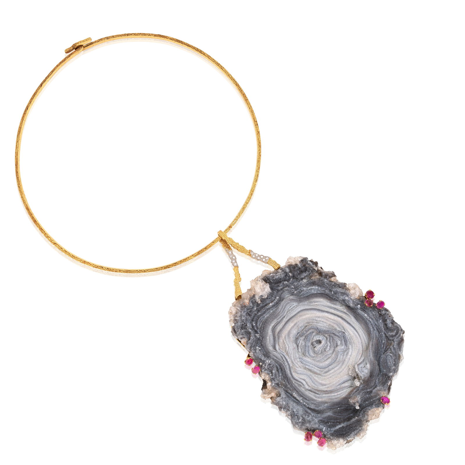 GRIMA: AGATE GEODE 'ROCK REVIVAL' PENDANT NECKLACE, 1971: GRIMA: AGATE GEODE 'ROCK REVIVAL' PENDANT NECKLACE, 1971 The large agate geode accented by oval-shaped cabochon rubies and brilliant-cut diamonds, suspended from a textured torque, mounted in yellow g