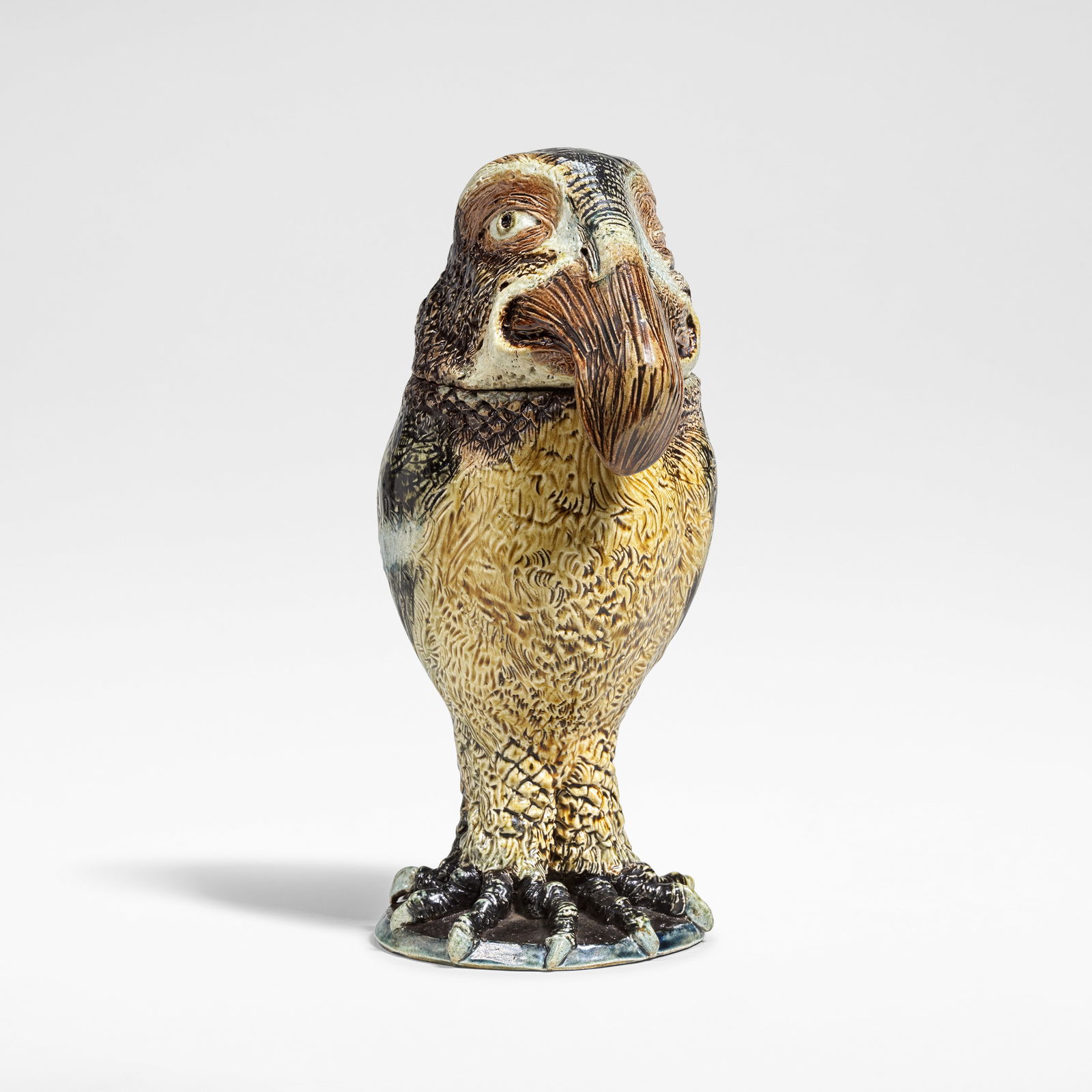 Robert Wallace Martin for Martin Brothers 'Wally Bird' tobacco jar and cover, 1884: Robert Wallace Martin for Martin Brothers 'Wally Bird' tobacco jar and cover, 1884 Stoneware, salt-glazed in tones of brown, green, cream, and blue. 28.2 x 12.6 x 15 cm Tail incised R.W.Martin./London