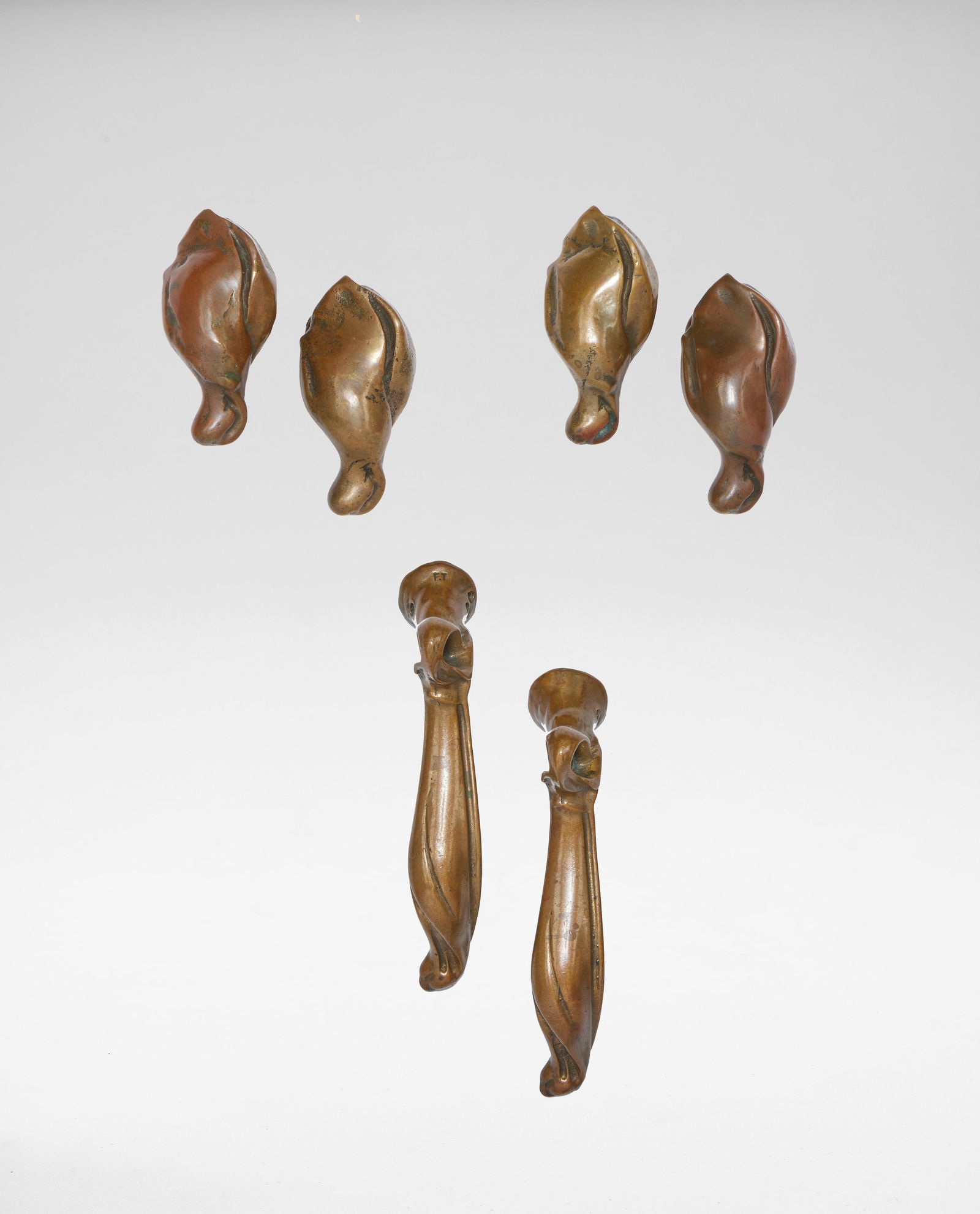 Hector Guimard Three sets of door handles, circa 1900: Hector Guimard Three sets of door handles, circa 1900 Patinated bronze. Largest pair, each: 11 x 6.6 x 2.2 cm One of the largest pair stamped F.T.