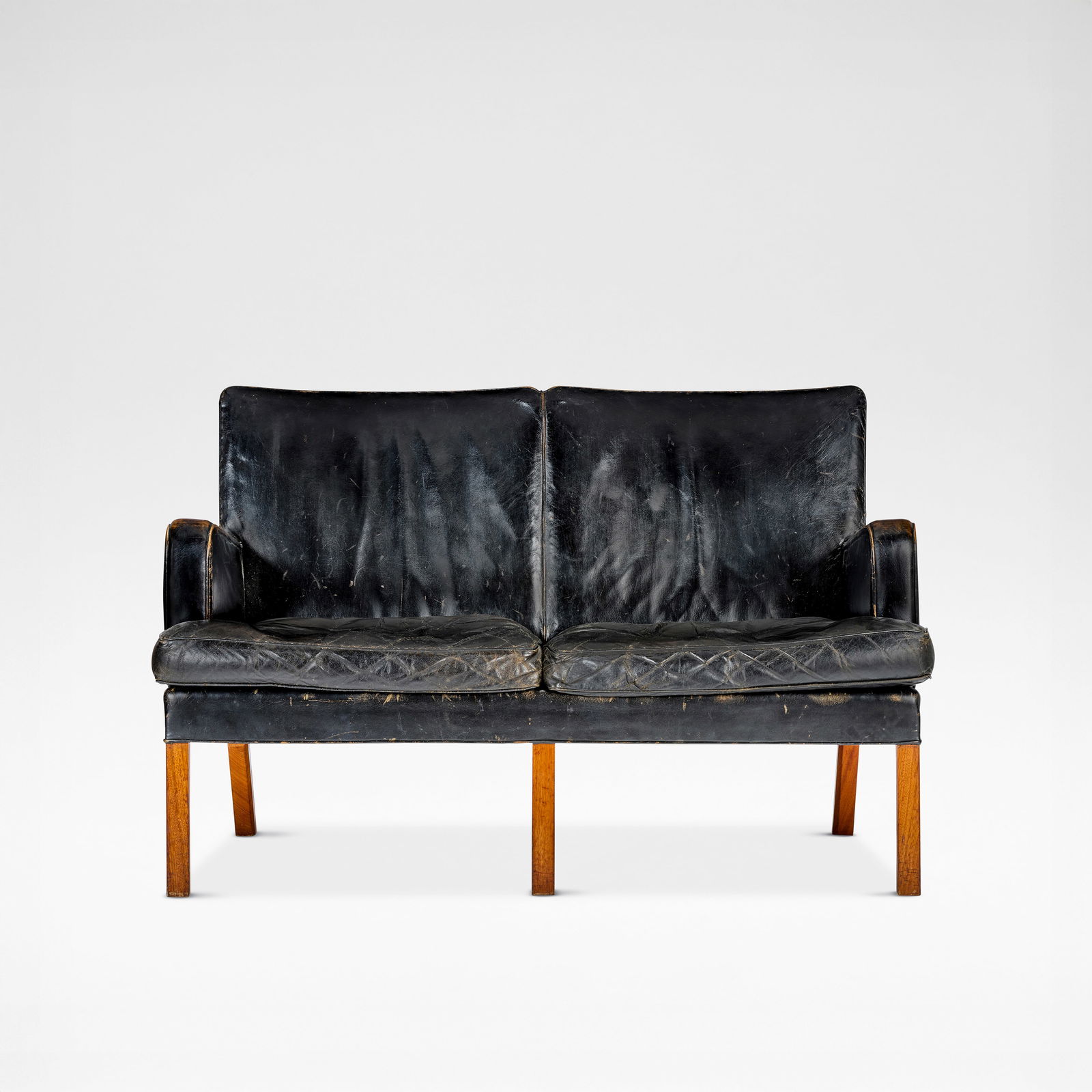Kaare Klint Two-seater sofa, model no. 5313, designed 1935, produced circa 1935-1945: Kaare Klint Two-seater sofa, model no. 5313, designed 1935, produced circa 1935-1945 Mahogany, leather. 82 cm high, 128 cm wide, 69 cm deep Executed by cabinetmakers Rud. Rasmussen A/S, Copenhagen, De