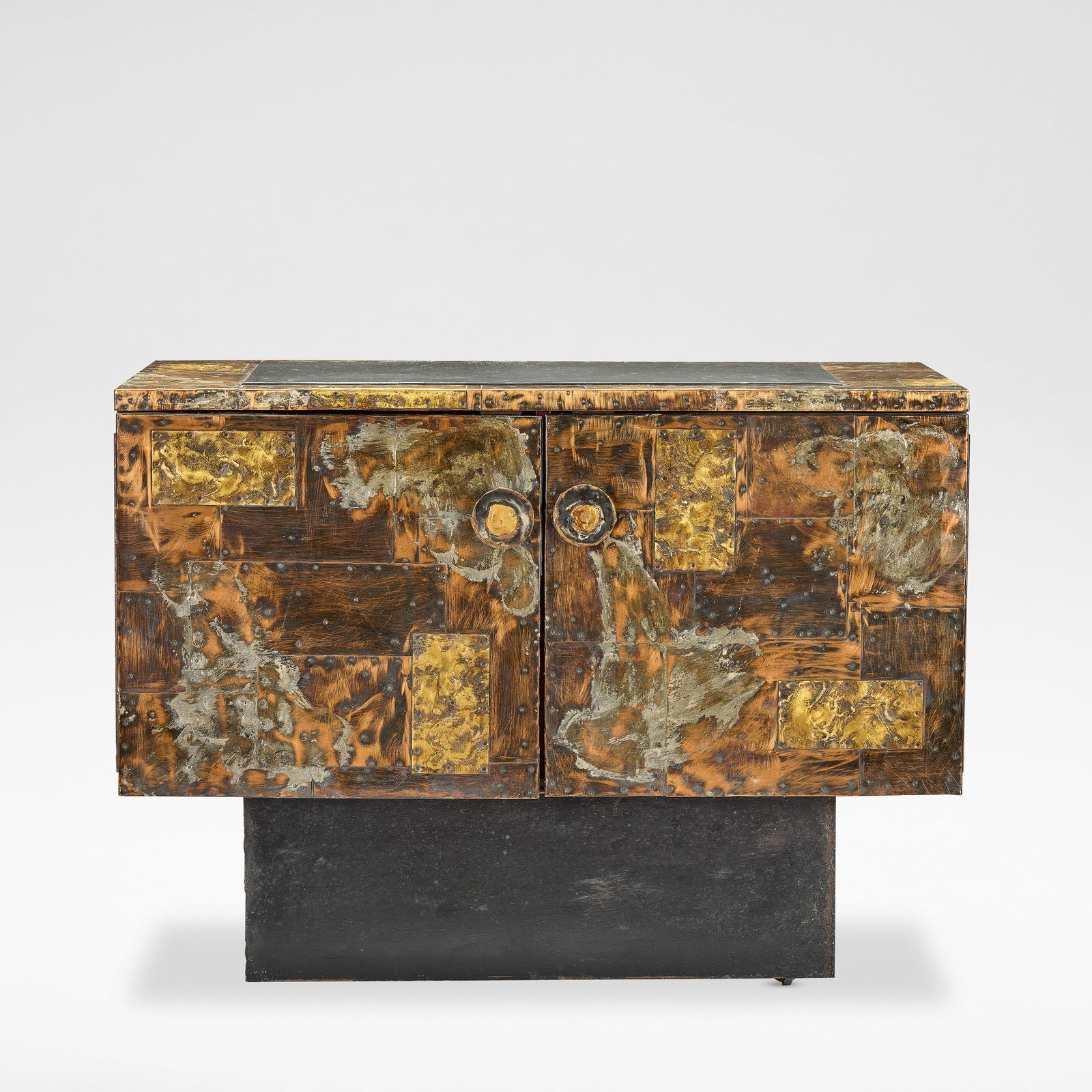 Paul Evans 'Patchwork' cabinet, circa 1970: Paul Evans 'Patchwork' cabinet, circa 1970 Welded and patinated copper and brass, aluminium, enamelled steel, surmounted by a slate top, the pair of doors opening to a lacquered interior enclosing a s