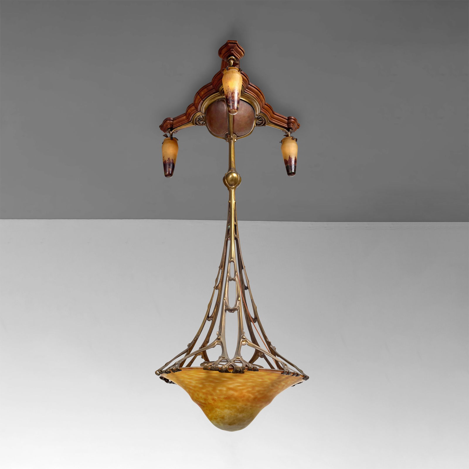 LOUIS MAJORELLE (1859-1926) AND DAUM FRERES (EST. 1878) Chandeliercirca 1900gilt bronze, glass i...: LOUIS MAJORELLE (1859-1926) AND DAUM FRERES (EST. 1878) Chandelier circa 1900 gilt bronze, glass internally decorated, bronze stamped 'J. Cayelle Nancy', pendant shades engraved 'Daum Nancy' with the
