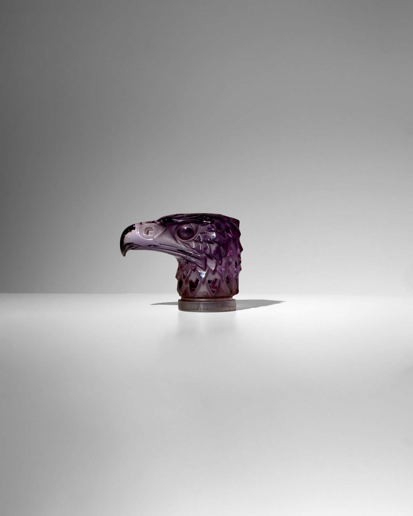 RENÉ LALIQUE (1860-1945) Tête d'Aigle (Eagle Head) designed 1928 Marcilhac 1138, rare...: RENÉ LALIQUE (1860-1945) Tête d'Aigle (Eagle Head) designed 1928 Marcilhac 1138, rare deep amethyst tinted glass, hand finished, molded mark 'R. LALIQUE FRANCE' height 4 1/4in (11cm); length