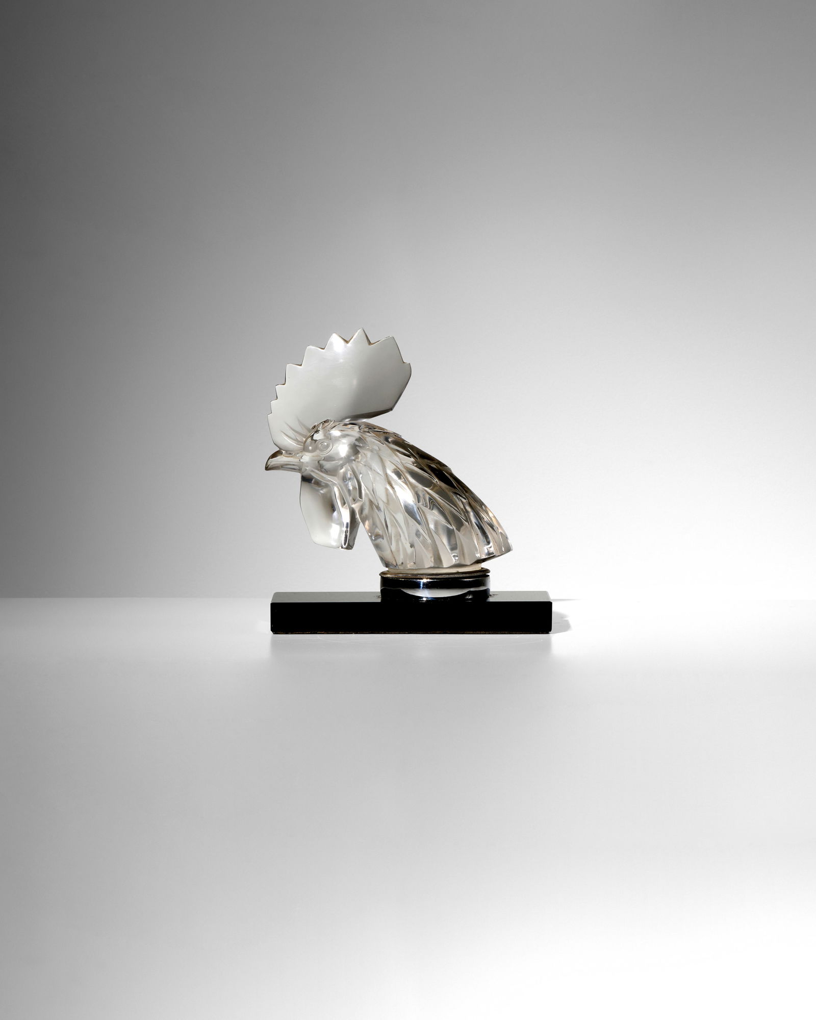 RENÉ LALIQUE (1860-1945) Tête de Coq (Rooster Head)Marcilhac 1137, clear and frosted g...: RENÉ LALIQUE (1860-1945) Tête de Coq (Rooster Head) Marcilhac 1137, clear and frosted glass, hand finished, molded mark 'LALIQUE FRANCE', on a Vitrolite bookend base, on chrome plated steel