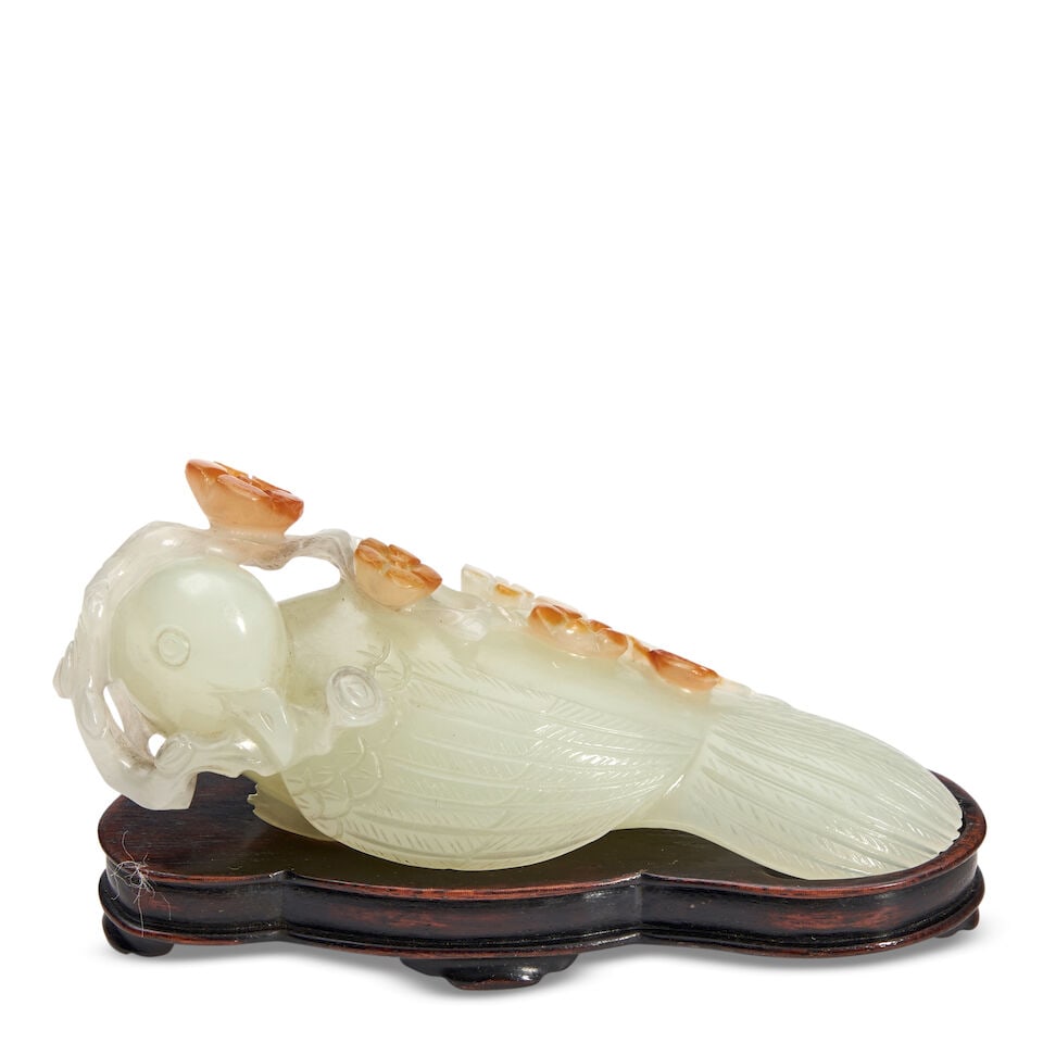 A Celadon And Russet Jade Carving Of A Bird Holding A Flowering Branch, China, 20th century, (1 of 2)