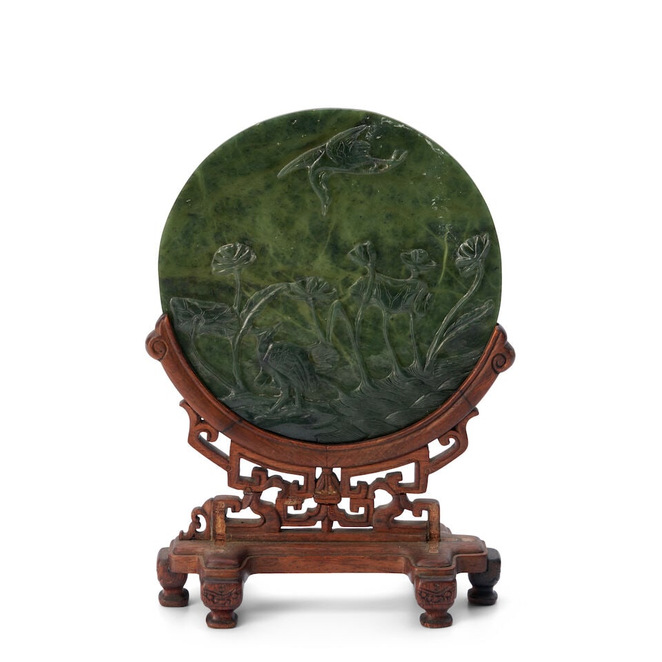 A Spinach Jadeite Round Plaque on an Openwork Stand China, 19th/20th century, (1 of 2)