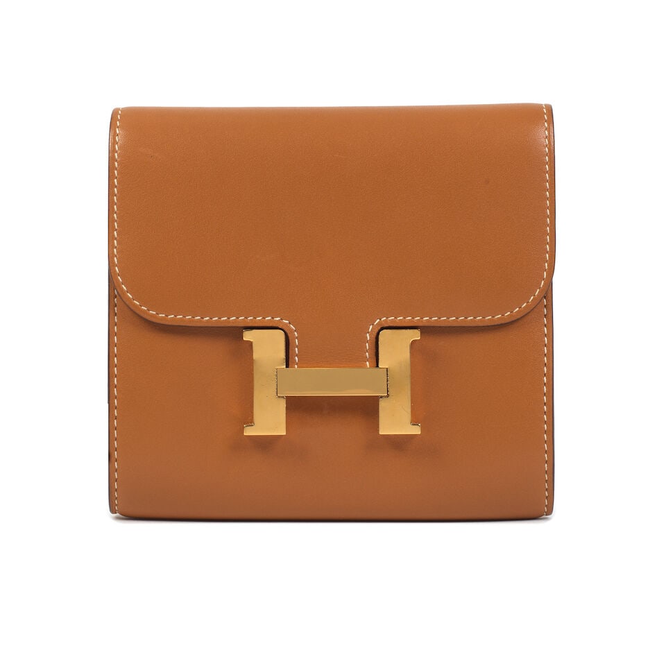 Hermès: a Natural Sable Butler Leather Constance Compact Wallet 2019: Hermès: a Natural Sable Butler Leather Constance Compact Wallet 2019 Central zipped compartments and card slots, slip pocket to reverse and gold hardware Condition Grade B- 13cm wide, 12cm