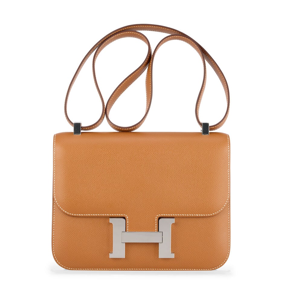 Hermès: a Gold Epsom Leather Constance 24 2022 (includes dust bag, a copy of receipt and box): Hermès: a Gold Epsom Leather Constance 24 2022 Palladium hardware Condition Grade B+ 23cm wide, 17.5cm high, 4cm deep, 25cm/45cm shoulder drop, includes dust bag, a copy of receipt and box For