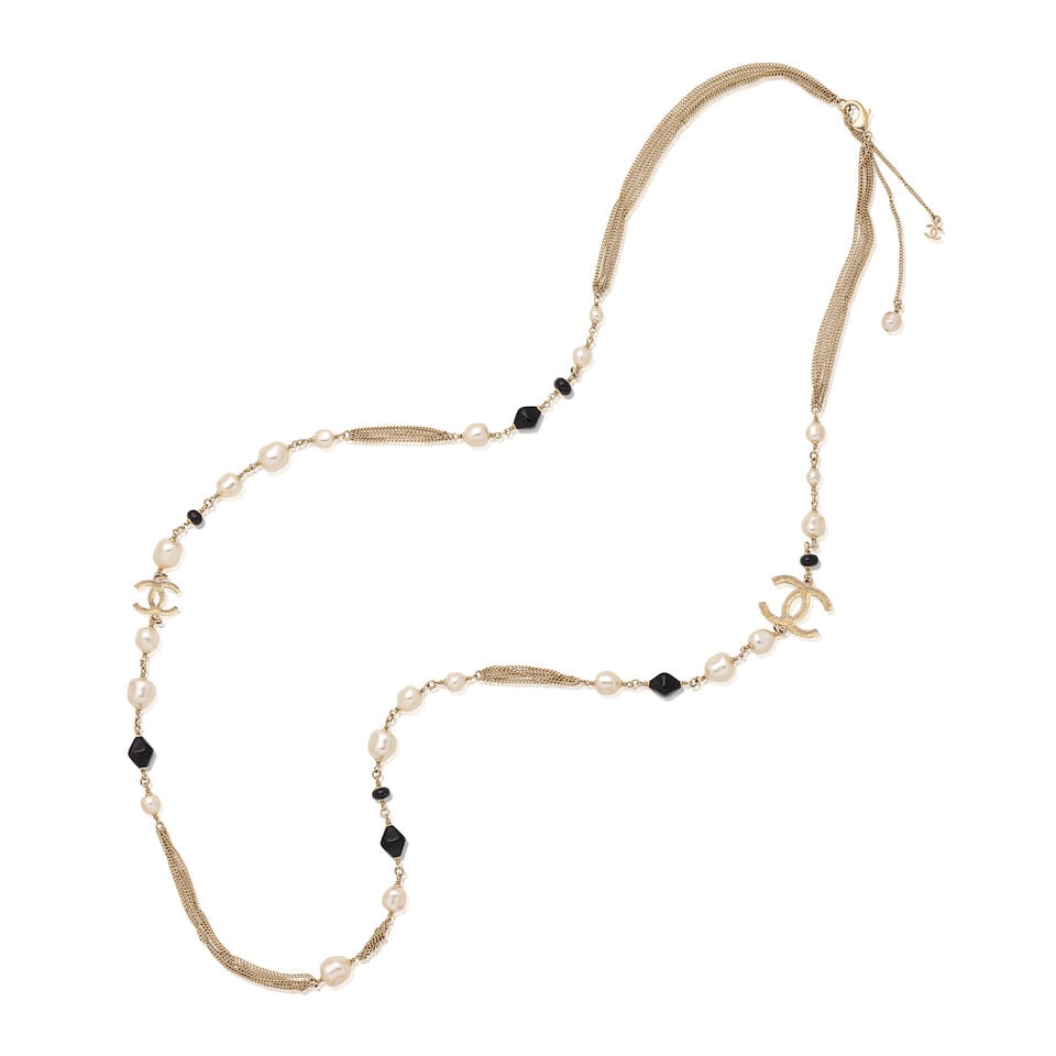 Chanel: a Simulated Baroque Pearl, Black Beads and CC Long Necklace Autumn 2012 (includes dust bag): Chanel: a Simulated Baroque Pearl, Black Beads and CC Long Necklace Autumn 2012 CC charms decorated with clear, grey and black crystals, black beads and simulated pearls set in champagne gold chain Co