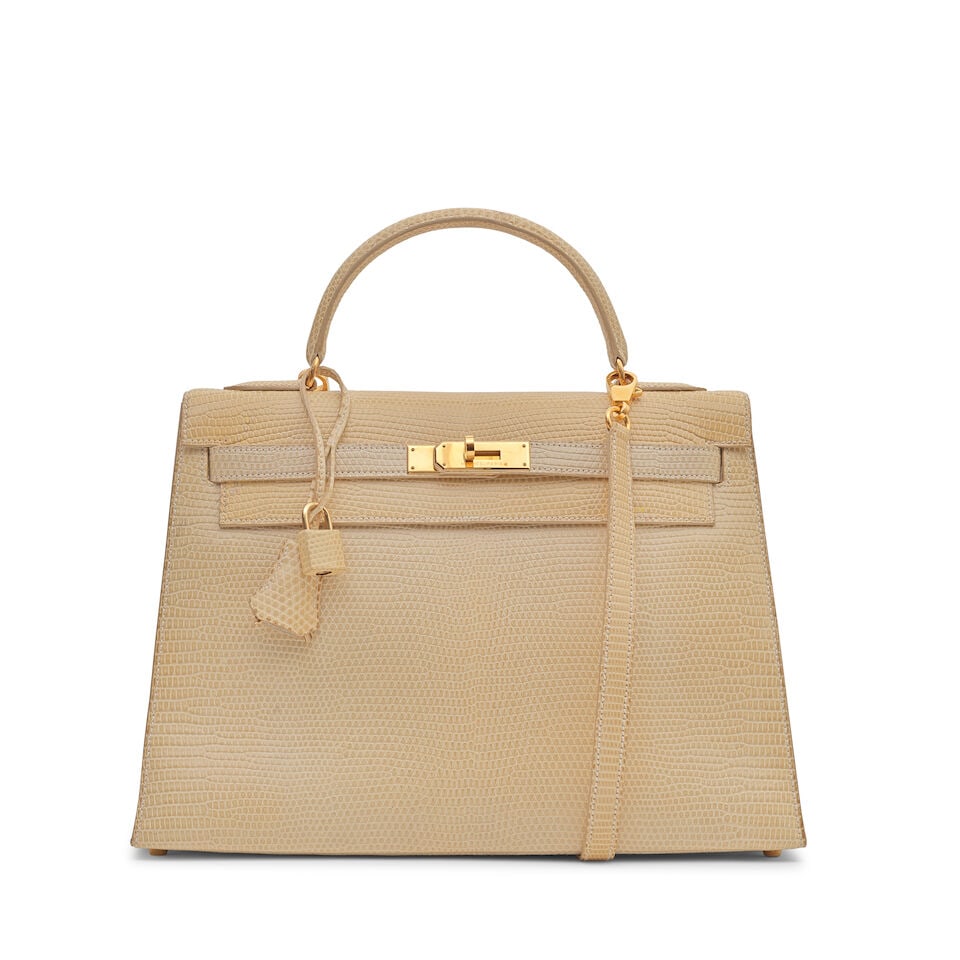 Hermès: a Shiny Blanc Casse Niloticus Lizard Sellier Kelly 32 1997 (includes padlock, keys...: Hermès: a Shiny Blanc Casse Niloticus Lizard Sellier Kelly 32 1997 Gold tone hardware Condition Grade B- 32cm wide, 23cm high, 12cm deep, 8cm handle drop, 43cm shoulder drop, includes padlock,
