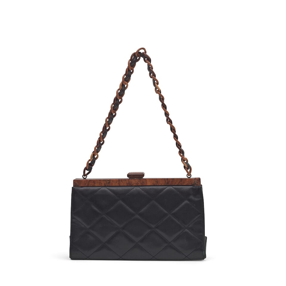 Chanel: a Black Quilted Leather and Wooden Frame Shoulder Bag 2000-02 (includes serial sticker a...: Chanel: a Black Quilted Leather and Wooden Frame Shoulder Bag 2000-02 Creative Director: Karl Lagerfeld Black leather with wooden frame and leather threaded wooden shoulder strap, CC clasp Condition G