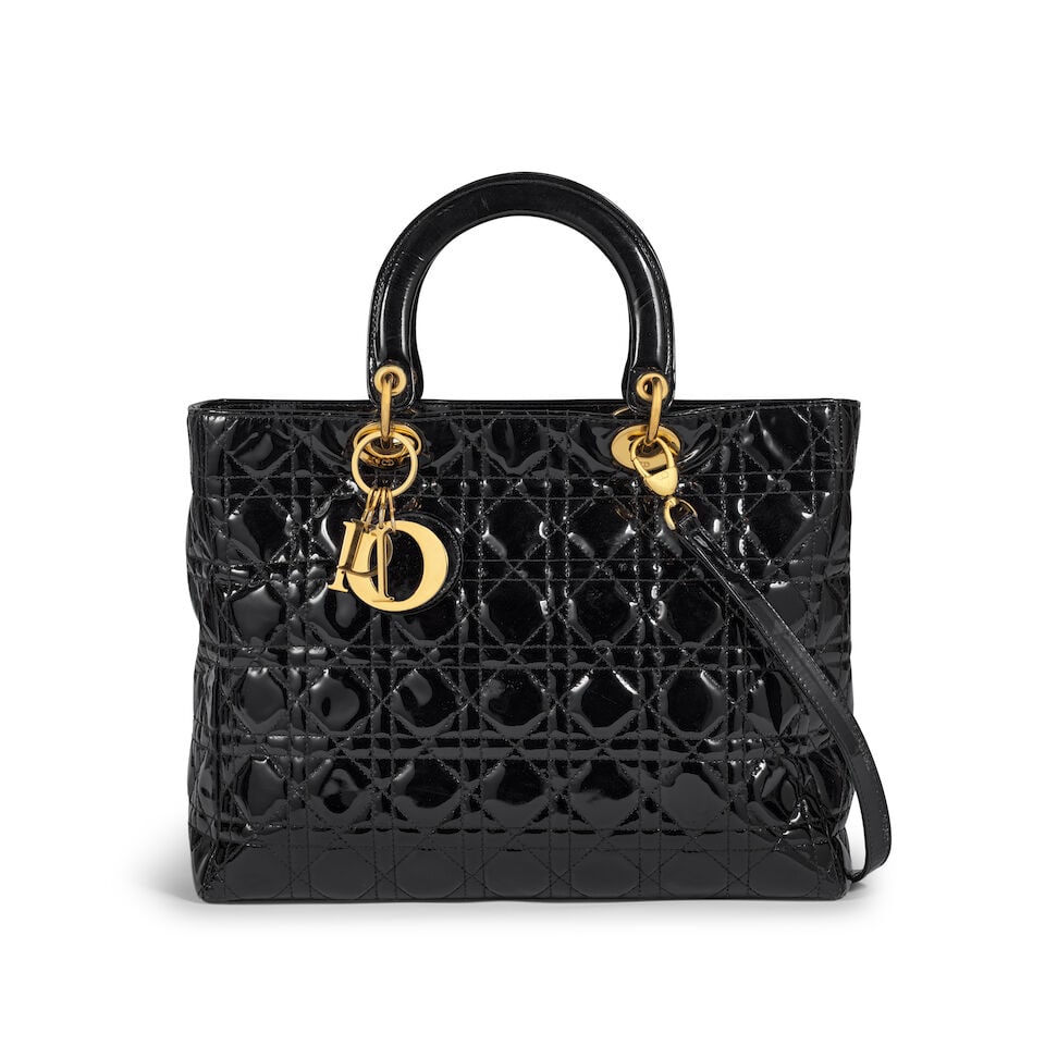 Christian Dior: a Black Patent Cannage Large Lady Dior Pre-1997 (includes shoulder strap): Christian Dior: a Black Patent Cannage Large Lady Dior Pre-1997 Soft patent leather with gold tone hardware Condition Grade C+ 32cm wide, 24cm high, 12cm deep, 10cm handle drop, 45cm shoulder drop,